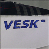 Готовая вышивка логотипа Vesk на воротнике
