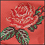 Machine embroidery of a rose with a cross