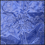 Фото вышивки яркого цветка на синей органзе